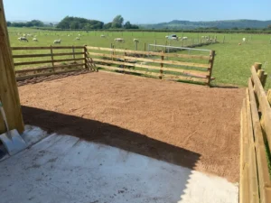 Wooden fencing near a farm on a horse pasture